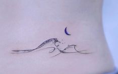 a woman's stomach with a small bird on it and the moon in the background