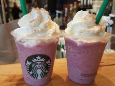 two starbucks drinks with whipped cream on top