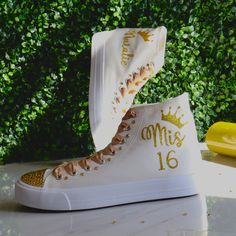 Golden or any other favorite Quinceañera color, you can modify the design. Quinceañera Hand-made Sneakers, for the celebration of a girl's 15th birthday, marking her passage from girlhood to womanhood. Make a statement with stunning decorated sneakers canvas, bedazzled with rhinestones, glitter, and other beautiful details. Make this spectacular gift as a real Queen Gift adding a tiara to your order :). See details below.  🌟Includes🌟 - Pick shoelace colors.  - The toe top is covered with bright rhinestones (mixing primary and secondary colors). - On the sides of the shoe (right & left), the idea/name/date is printed in solid or glitter color. - The back has the year printed. 🧡You will receive🧡 - One pair of sneaker canvas off-brand - One pair of delicate Silk laces - One special custom Decorated Sneakers, Quinceanera Shoes, Birthday Shoes, Queen Gifts, Secondary Colors, Primary And Secondary Colors, Party Dance, 15 Gifts, Blue Party