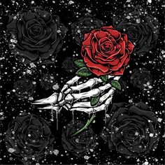 a skeleton hand holding a red rose in the middle of black and white roses with sprinkles