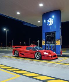 a red sports car parked in front of a gas station