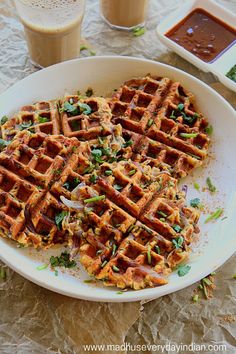 two waffles on a plate with sauce and condiments