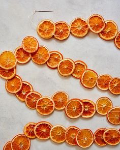 orange slices are arranged in the shape of a number on a white surface with thread