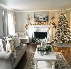 a living room filled with furniture and a fire place covered in christmas tree decorations on top of a hard wood floor