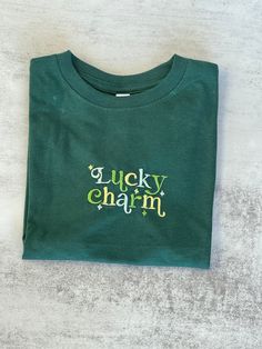 This unisex toddler-sized t-shirt is embroidered with an adorable "Lucky Charm" graphic that will stand out in a sea of shamrocks this St. Patrick's Day! Please be sure to check the size chart for your size. If you're interested in another color shirt or different sizes (infant bodysuits or adult shirts), please reach out. I'm slowly getting them all added to the shop, but they ARE available even if you don't see a listing! Sweatshirt details:  - 4.5 oz., 100% combed ringspun cotton fine jersey - Shoulder-to-shoulder self-fabric back neck tape - CPSIA Compliant tracking label in side seam - Double needle sleeves and bottom hem - Machine washable/ tumble dry low - Side seam construction - Topstitched ribbed collar - EasyTear™ label Shamrock Embroidery, Sweatshirt Details, St Paddys, St Paddys Day, St Paddy, Paddys Day, Adulting Shirts, Color Shirt, Lucky Charm