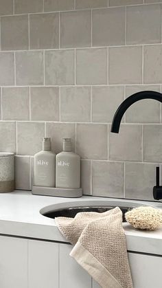 a black faucet sitting on top of a kitchen counter next to a sink