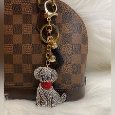 a brown purse with a dog keychain on it