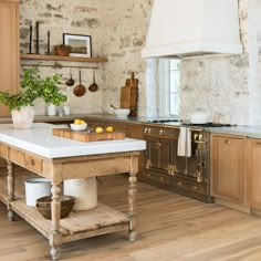 a kitchen with an island in the middle and wooden cabinets on both sides, surrounded by wood flooring