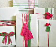 several wrapped presents with pink and green ribbons