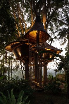 a gazebo in the middle of some trees with lights on it's sides