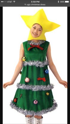 a woman in a green christmas dress with decorations on her head and yellow star above her head