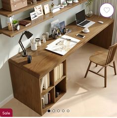 a wooden desk topped with lots of shelves filled with books and office supplies next to a window