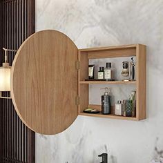 an open wooden cabinet on the wall with various items in it, including soaps and lotion