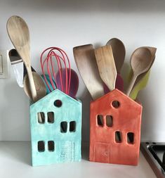 three wooden utensils and spoons are sitting next to each other on a counter