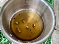 a metal bowl filled with oil and some nuts