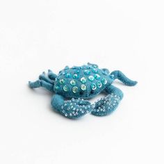 a blue crab with lots of bubbles on it's back