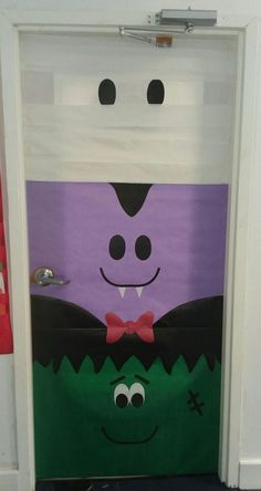 a door decorated to look like a monster with a bow tie and mouthy eyes