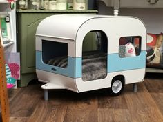 a white and blue trailer bed sitting on top of a wooden floor