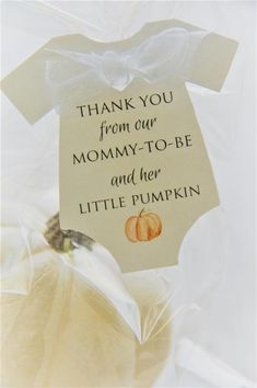 a thank you from our mommy - to - be and her little pumpkin tag on a bag