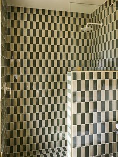 a bathroom with black and white tiles on the walls