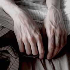 a person with their hands on the bed