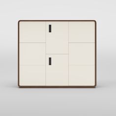 a white and brown cabinet with two black square knobs on each side, in front of a gray background