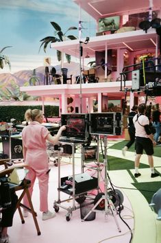 a woman standing in front of a television set