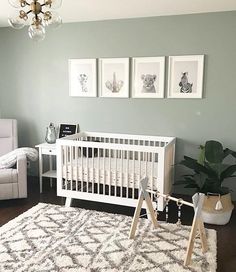 a baby's room with grey walls and white furniture