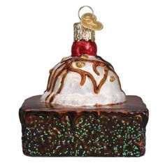 a chocolate cake ornament with frosting and sprinkles