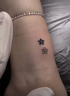 a woman's foot with four clovers tattoo on her left side calfocks