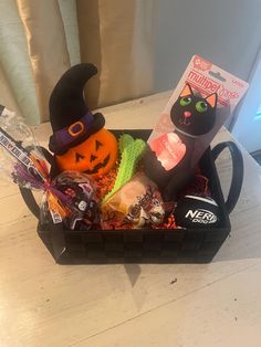 a basket filled with halloween treats on top of a table