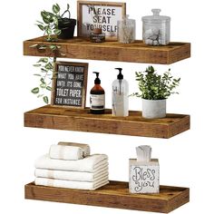 three wooden shelves with towels, soaps and plants