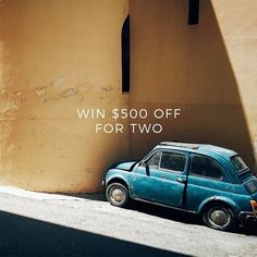 an old blue car parked in front of a building with the words win $ 500 off for two