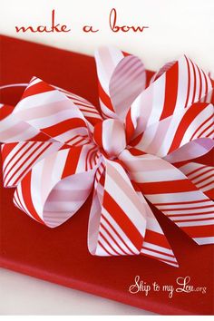 a red and white striped bow on top of a red box with the words skip to my love