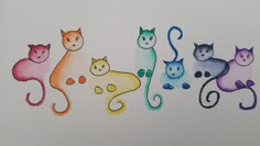 four different colored cats sitting next to each other on top of a white sheet with watercolor