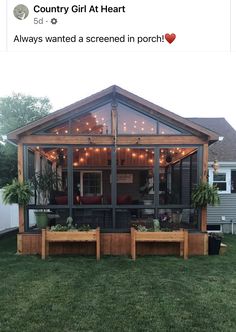 an image of a screened in porch with lights on the roof and plants growing inside