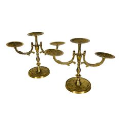 three brass candelabra candlesticks on white background