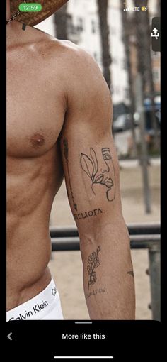 a shirtless man with tattoos on his arm