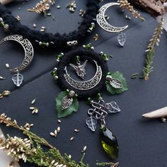 Introducing our stunning Moon Forest necklace! This exquisite piece is carefully crafted using recycled materials, with an eye for detail and a touch of love. The necklace features a gorgeous green moss Swarovski crystal, surrounded by delicate green acrylic leaves and filigree moons. The combination of natural elements and intricate metalwork creates a magical forest-inspired design that will surely catch the eye of anyone who sees it. The necklace comes with our best wishes for whoever wears i Handmade Fantasy Necklaces For Larp, Handmade Fantasy Green Necklaces, Handmade Green Fantasy Necklaces, Green Handmade Fantasy Necklace, Handmade Fairycore Festival Necklaces, Handmade Green Fantasy Necklace, Handmade Fairycore Necklaces For Festivals, Handmade Magical Style Green Jewelry, Handmade Magical Necklaces For Festival