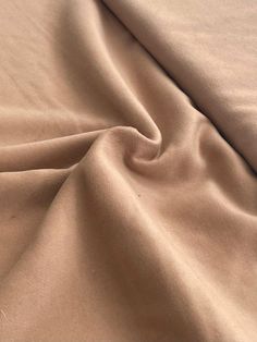 a close up view of a tan colored fabric