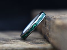 This amazing women's ring features a green malachite stone inlay in a narrow titanium band for a clean, modern look. Wear it alone, or stack it with other rings for an even more unique look! Every Richter Scale ring is covered by our 100% lifetime guarantee Typically ships within weeks, not months like some! About This Ring- Resizing- This ring can be resized up or down as much as 1 full size (See policies for details) Materials- Titanium, Malachite stone inlay Finish- Polished Care Instructions Polished Emerald Ring For Wedding, Polished May Birthstone Jewelry For Weddings, Wedding Jewelry With Polished Emerald, Elegant Green Rings With Inlay, Elegant Green Inlay Rings, Green Malachite Rings With Polished Finish, Green Malachite Rings For Anniversary, Green Inlay Rings For Anniversary, Green Stainless Steel Ring As A Gift