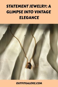 Gold necklace with a pendant displayed on a satin fabric background. Text reads "Statement Jewelry: A Glimpse into Vintage Elegance". Vintage Statement Jewelry, Vintage Elegance, Layered Jewelry, Individual Style, Bold Fashion, Jewelry Trends, Statement Jewelry, Timeless Pieces, Fashion Games