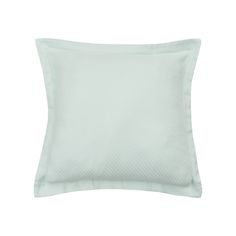 a light green pillow on a white background