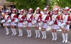 a group of women in red and white marching uniforms