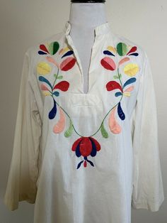 "For your consideration Vintage floral embroidered tunic top. I think it is from the 60s but can't say for sure. The original owner did a lot of traveling over many decades. Feels like cotton and fits like a modern S/M. Nice piece. Good lookin! Pre owned, shows general wear. Overall nice condition. Has faint age discoloration in areas and minor snags on the embroidery. Minor fraying. Has not been recently cleaned but I did heat steam it. Please review photos and message with any questions Measur Spring Folk Tunic With Floral Embroidery, Cotton Tunic Blouse With Floral Embroidery, Multicolor Cotton Peasant Embroidered Top, Spring Embroidered Cotton Tunic, Casual Cotton Tunic With Floral Embroidery, Multicolor Cotton Embroidered Peasant Top, Multicolor Embroidered Tunic For Spring, Cotton Tunic With Floral Embroidery For Spring, Cotton Folk Embroidered Top For Vacation