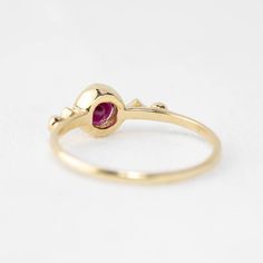 This 14k gold uniquely designed Ruby ring will make the perfect alternative engagement ring for the non-traditional brides. This unique ring has a milgrain finish on the frame around the Ruby to give a vintage feel. Attached to the Ruby are two star-shaped settings with diamonds adding uniqueness and sparkle to the ring. Ruby is a very unique stone with many different meanings. It is the birthstone of July. 4.5mm ruby 0.04ctw G color SI clarity accent diamonds Band width: approx. 1.3mm Low profi Ruby Sapphire, Ruby Engagement Ring, July Birthstone Jewelry, July Birthstone, Alternative Engagement Rings, Ruby Ring, Opal Rings, Diamond Bands, Birthstone Jewelry