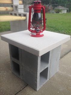 a red lantern sitting on top of a cement block