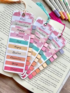 four bookmarks with the names of different books on them and some crayons