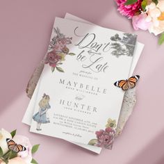 two wedding cards with butterflies on them next to some flowers and pink peonies