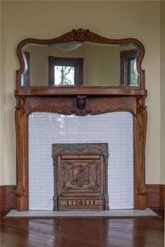 an old fireplace with a mirror above it